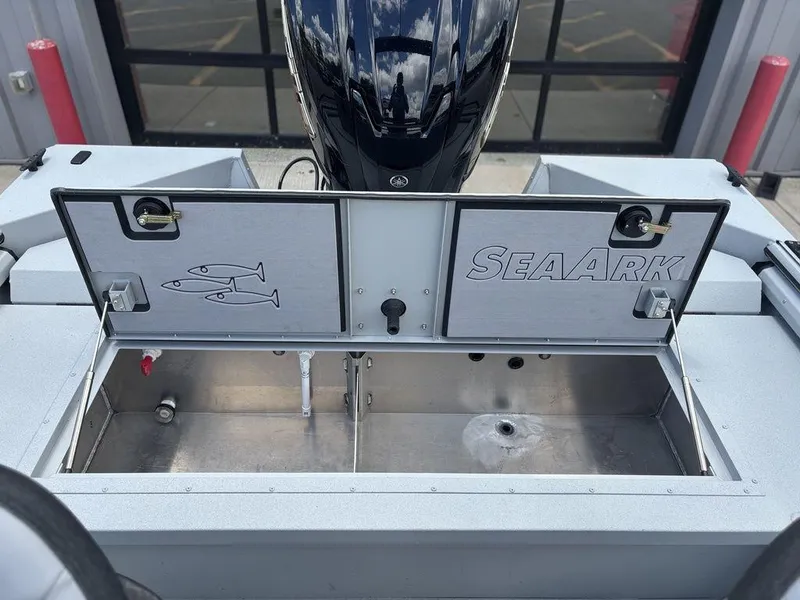 Slide: The Image of 2026 SeaArk ProCat 240 boat with open storage compartment and motor. - 23