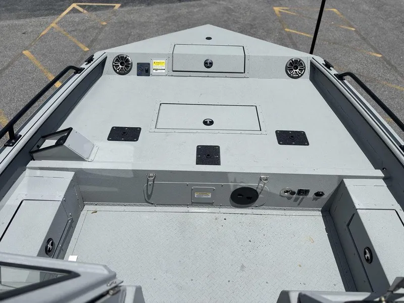 Slide: The Image of 2026 SeaArk ProCat 240 boat deck with storage compartments and speakers. - 7