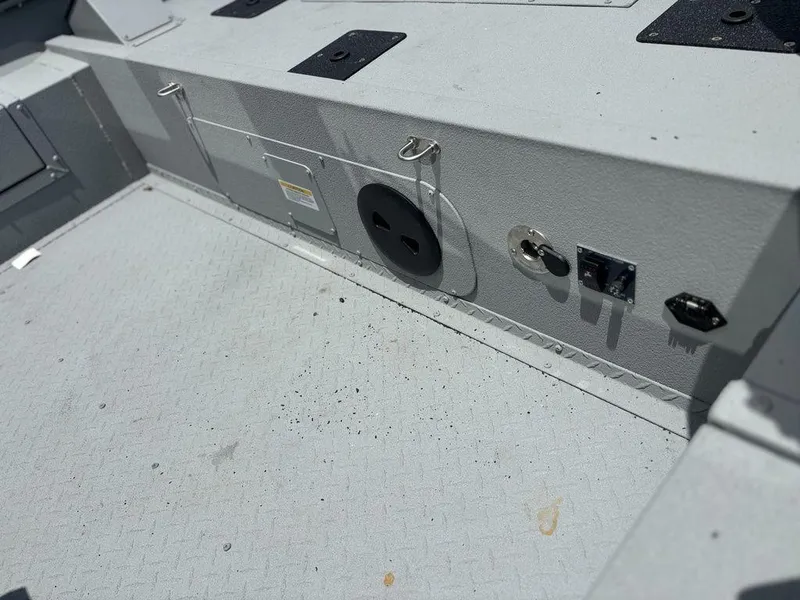 Slide: The Image of 2026 SeaArk ProCat 240 boat interior with utility panel and textured flooring. - 8
