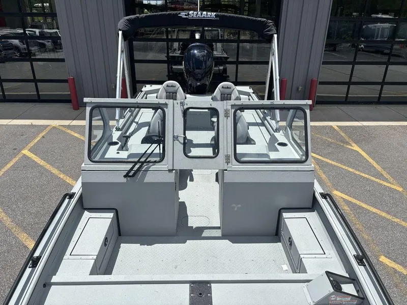 Slide: The Image of 2026 SeaArk ProCat 240 boat, spacious deck, dual consoles, parked outdoors. - 9