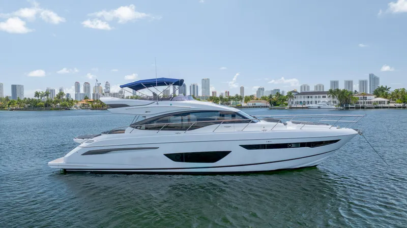 Slide: The Image of 2017 Princess S65 yacht on water with city skyline in background. - 1
