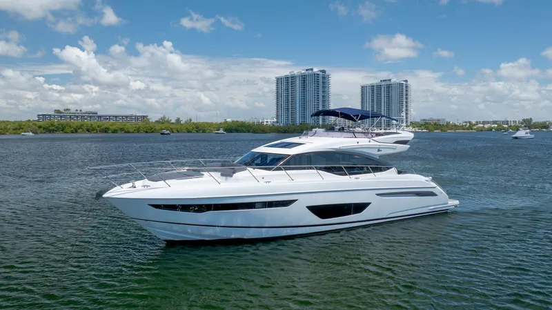 Slide: The Image of Luxurious 2017 Princess S65 yacht cruising on a sunny day with cityscape backdrop. - 2