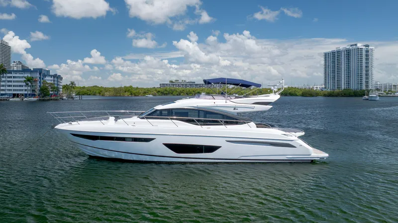 Slide: The Image of Luxury 2017 Princess S65 yacht cruising on a sunny day near urban waterfront. - 4
