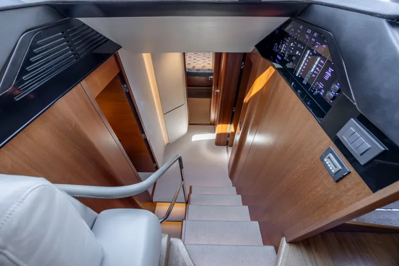 Slide: The Image of Luxurious interior of 2017 Princess S65 yacht, featuring elegant wooden stairs and modern control panel. - 45