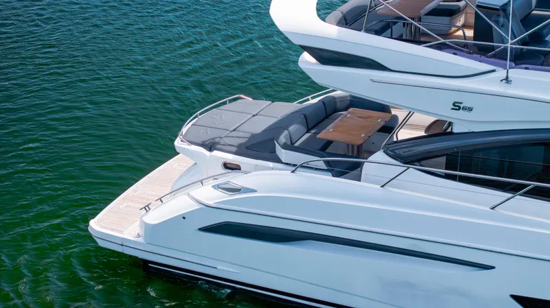 Slide: The Image of Luxury 2017 Princess S65 yacht on calm water, featuring sleek design and spacious deck. - 6