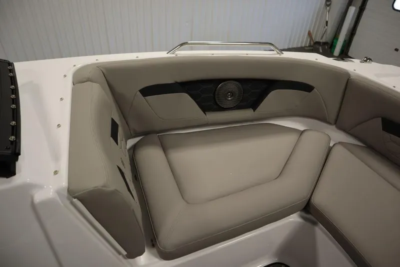 Slide: The Image of 2025 Four Winns HD3 boat interior with beige seating and speaker system. - 12