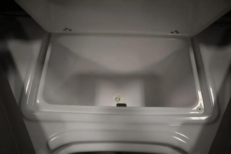 Slide: The Image of 2025 Four Winns HD3 storage compartment, open and empty, showcasing interior design. - 17