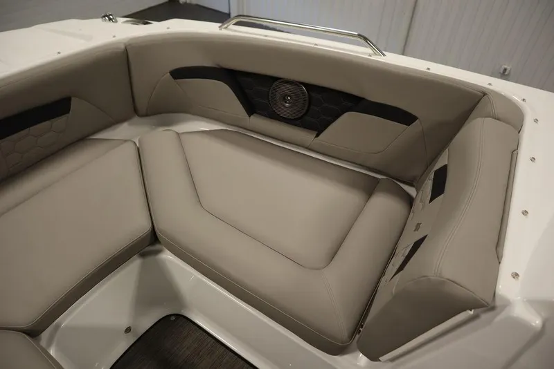 Slide: The Image of 2025 Four Winns HD3 boat interior with beige seating and speaker detail. - 18