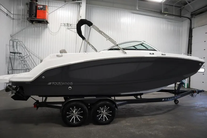Slide: The Image of 2025 Four Winns HD3 boat on trailer in indoor storage facility. - 2