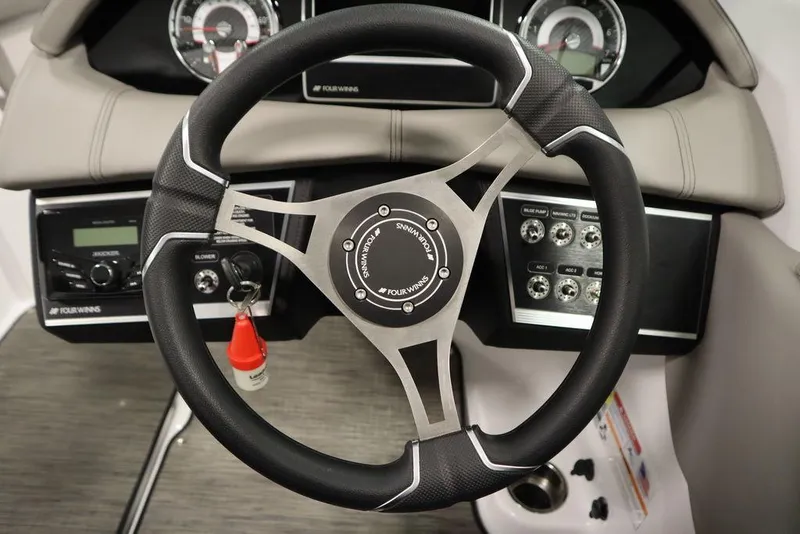 Slide: The Image of 2025 Four Winns HD3 steering wheel and dashboard controls. - 20