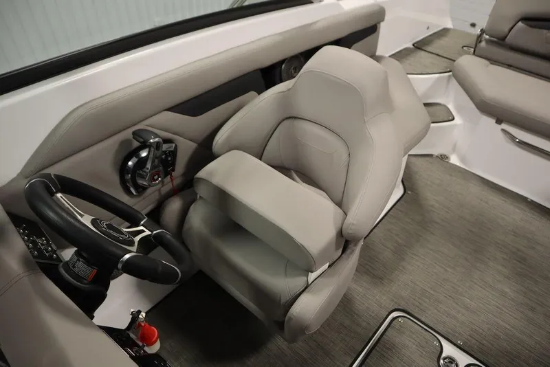 Slide: The Image of 2025 Four Winns HD3 boat interior with steering wheel and plush seating. - 23