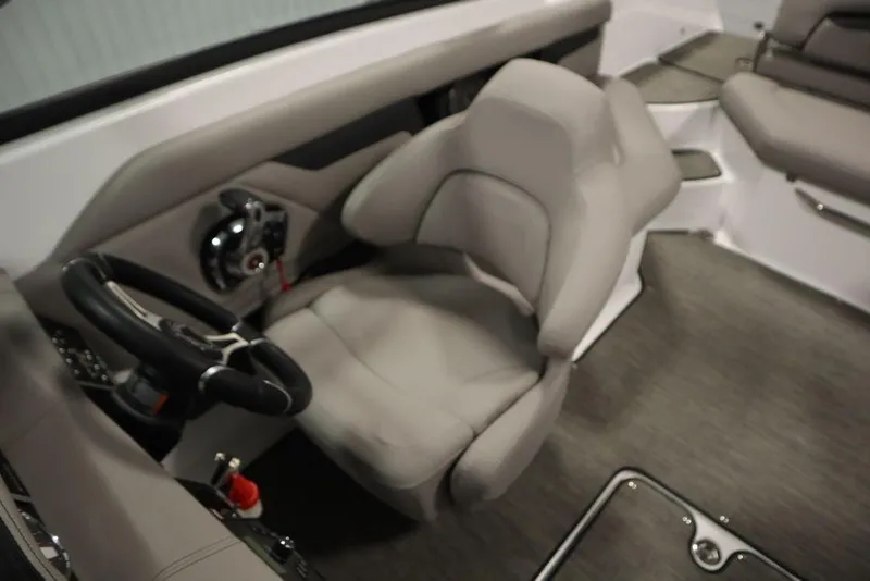 Slide: The Image of 2025 Four Winns HD3 boat interior with steering wheel and seating. - 25