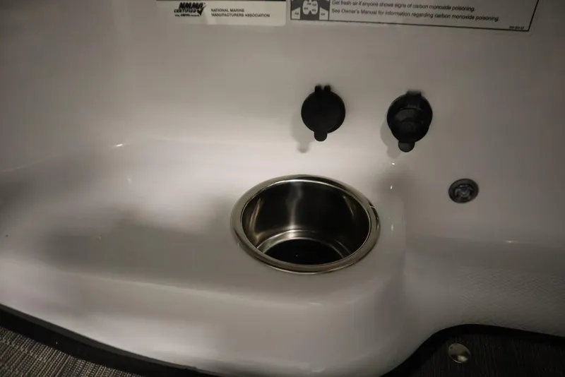 Slide: The Image of 2025 Four Winns HD3 boat interior with stainless steel cup holder and control panel. - 30