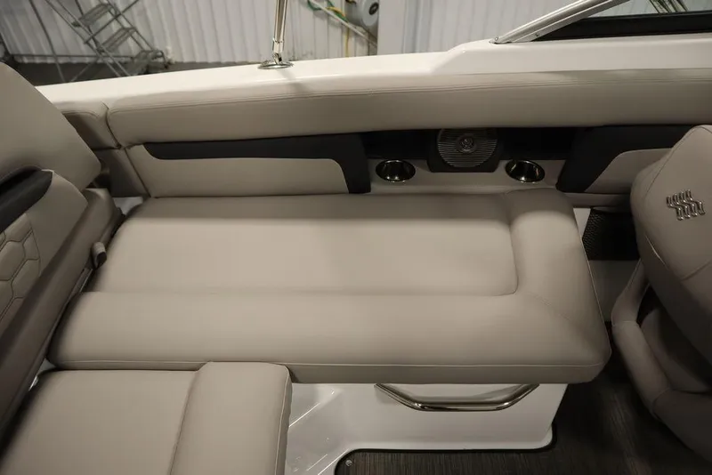 Slide: The Image of 2025 Four Winns HD3 boat interior with beige seating and cup holders. - 35