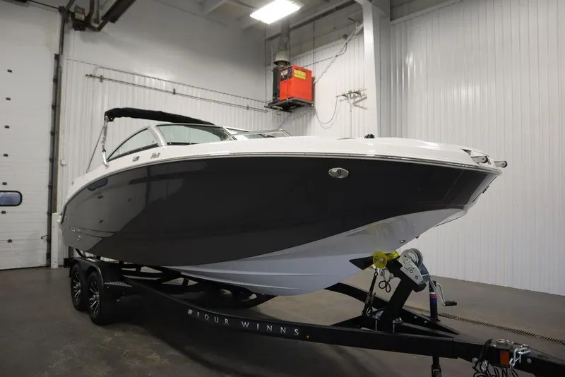 Slide: The Image of 2025 Four Winns HD3 boat on trailer in indoor storage facility. - 4