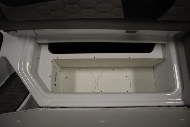 Slide: The Image of 2025 Four Winns HD3 boat storage compartment, open and empty, with sleek white interior design. - 40
