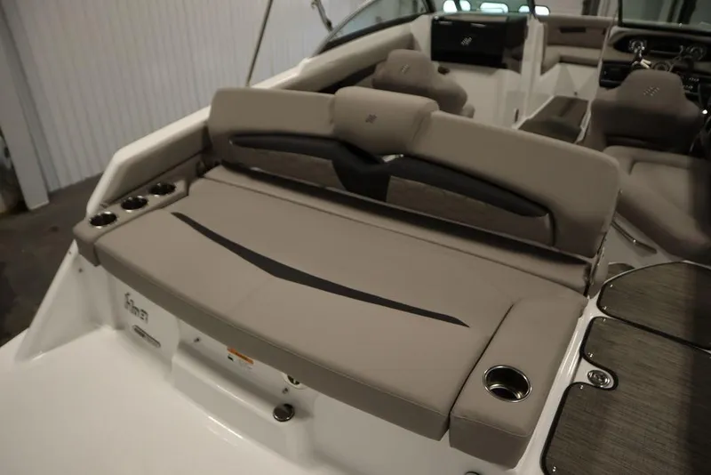 Slide: The Image of 2025 Four Winns HD3 boat interior with beige seating and cup holders. - 46