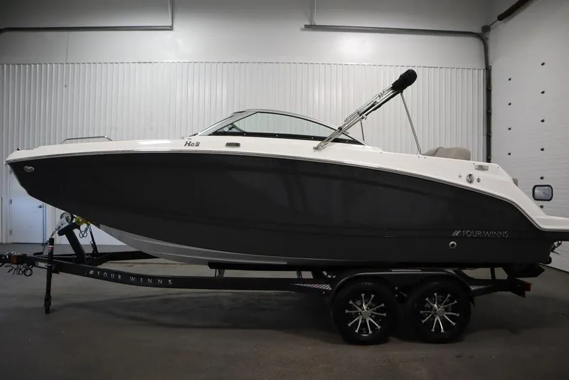 Slide: The Image of 2025 Four Winns HD3 boat in a showroom, side view on a trailer. - 9