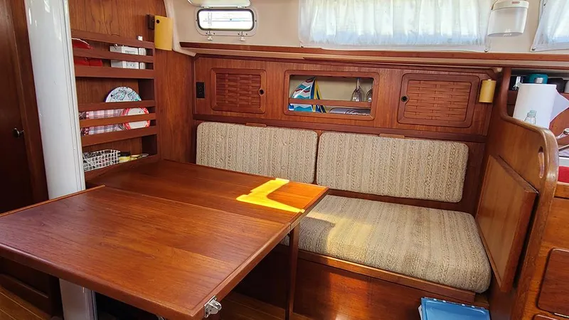 Slide: The Image of Interior of 1983 Sabre 34 sailboat with wooden table and cushioned seating. - 10