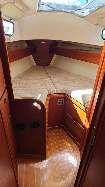 Slide: The Image of 1983 Sabre 34 sailboat interior with cozy V-berth and wooden cabinetry. - 12
