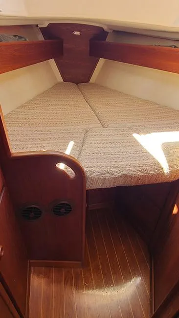 Slide: The Image of 1983 Sabre 34 sailboat interior cabin with cozy V-berth and wooden finish. - 13
