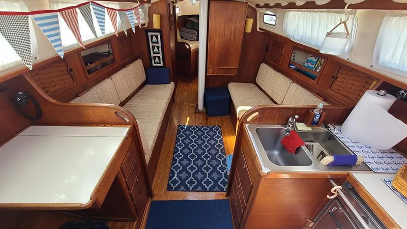 Slide: The Image of Interior of a 1983 Sabre 34 sailboat with wood finish and cozy seating area. - 6