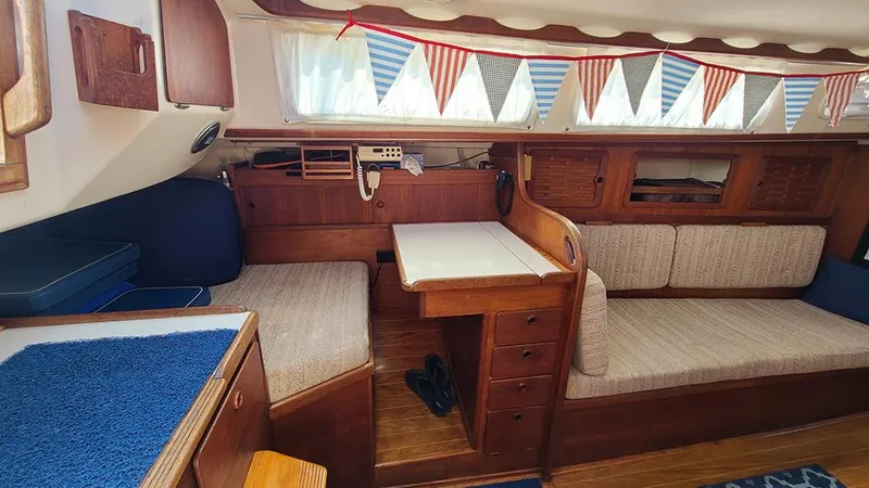 Slide: The Image of Interior of 1983 Sabre 34 sailboat with wooden furnishings and cozy seating area. - 7