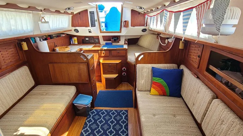 Slide: The Image of Interior of a 1983 Sabre 34 sailboat with cozy seating and nautical decor. - 9