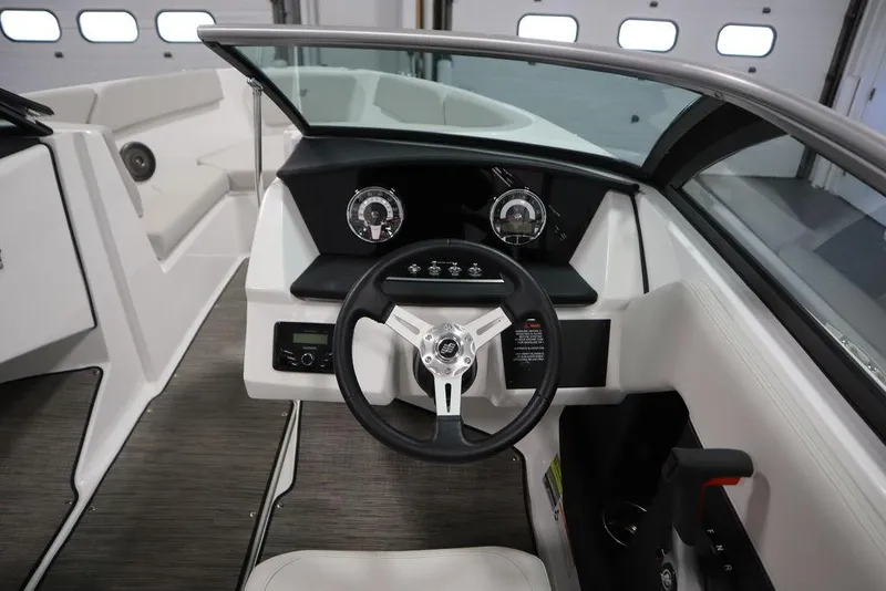 Slide: The Image of 2025 Four Winns H2 Freedom boat interior with modern steering wheel and dashboard controls. - 10