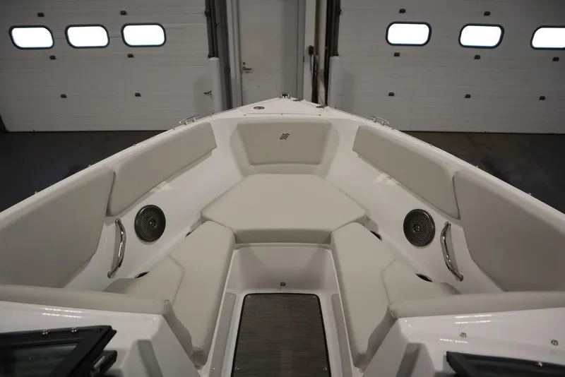 Slide: The Image of 2025 Four Winns H2 Freedom boat interior with cushioned seating and speakers. - 15