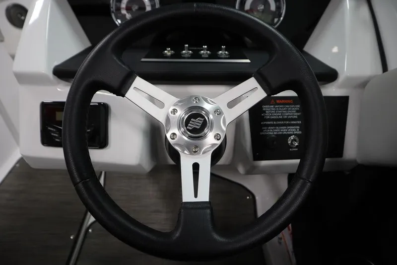 Slide: The Image of Steering wheel of 2025 Four Winns H2 Freedom boat, featuring sleek design and modern controls. - 17