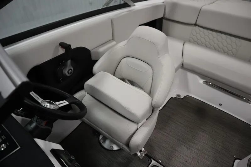 Slide: The Image of 2025 Four Winns H2 Freedom boat interior with plush seating and modern steering wheel. - 24