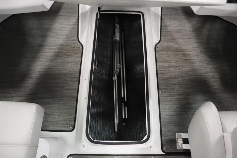 Slide: The Image of 2025 Four Winns H2 Freedom boat interior storage compartment with sleek design and modern flooring. - 27