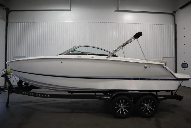 Slide: The Image of 2025 Four Winns H2 Freedom boat on trailer in indoor setting. - 3