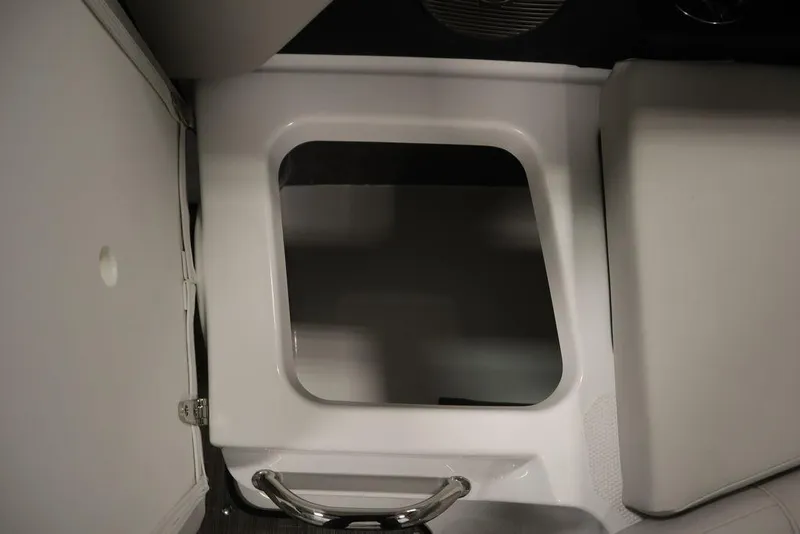 Slide: The Image of Interior compartment of 2025 Four Winns H2 Freedom boat, featuring sleek white design. - 31