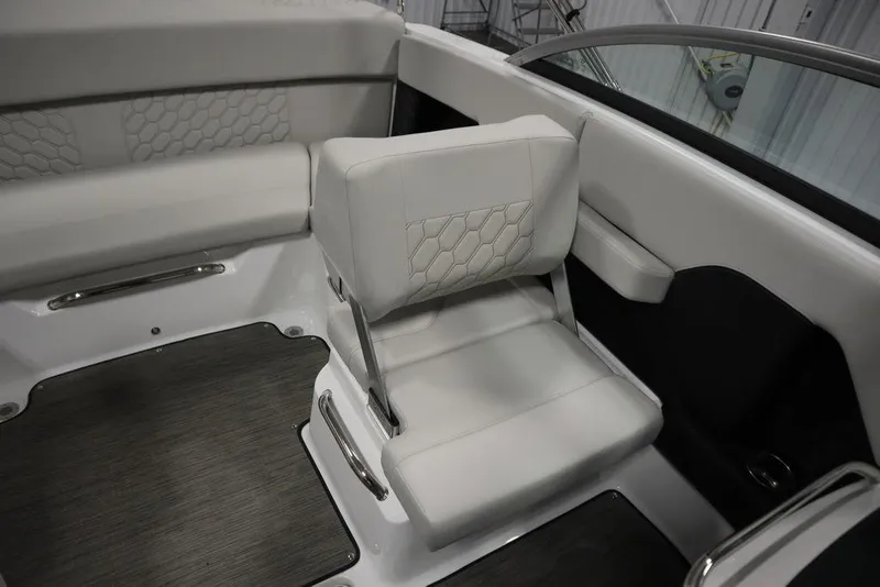 Slide: The Image of 2025 Four Winns H2 Freedom boat interior with white cushioned seating and modern design. - 32