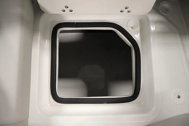 Slide: The Image of 2025 Four Winns H2 Freedom boat storage compartment with black trim. - 37
