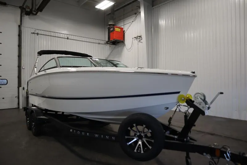 Slide: The Image of 2025 Four Winns H2 Freedom boat on trailer in indoor storage. - 4