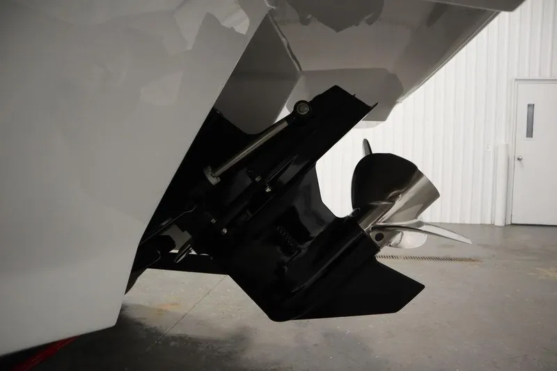 Slide: The Image of 2025 Four Winns H2 Freedom boat propeller and stern detail in a garage setting. - 44