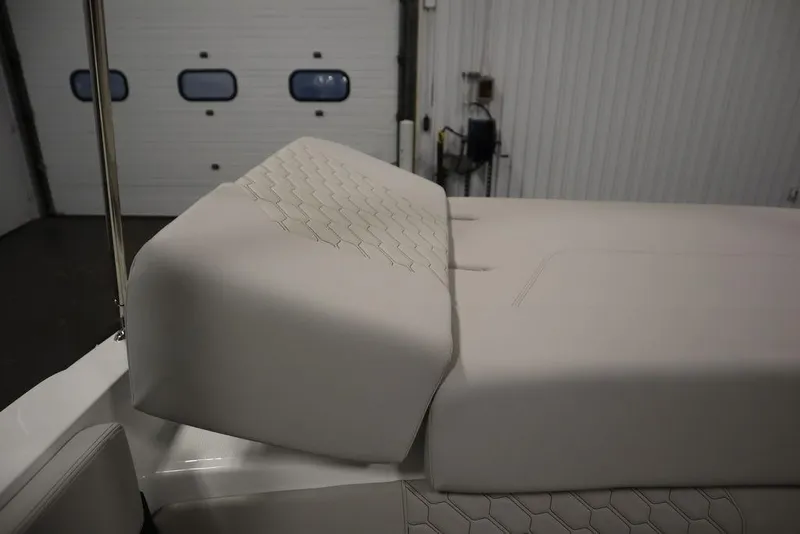 Slide: The Image of 2025 Four Winns H2 Freedom boat interior with white cushioned seating. - 45