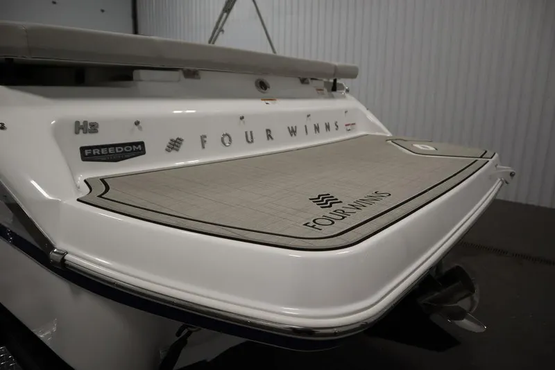 Slide: The Image of 2025 Four Winns H2 Freedom boat rear view with branded swim platform. - 46