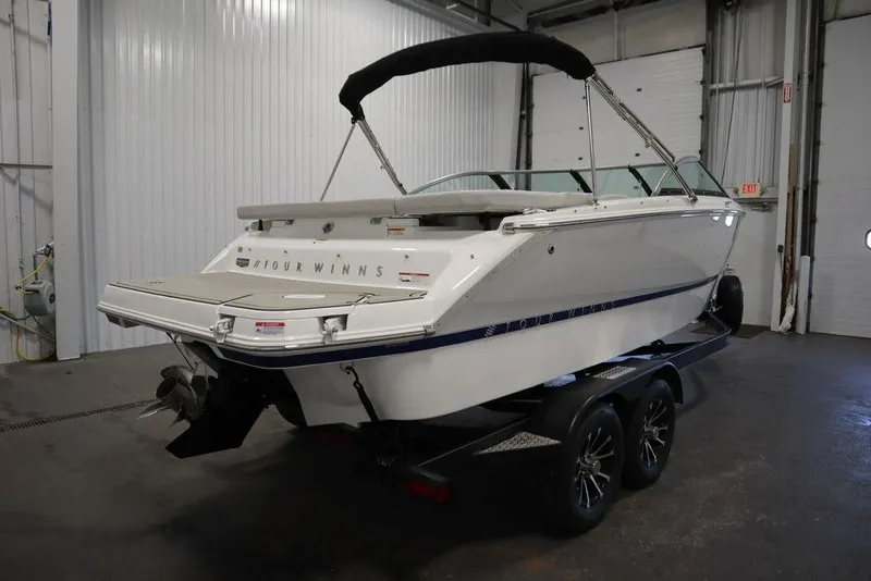 Slide: The Image of 2025 Four Winns H2 Freedom boat on trailer in indoor storage facility. - 5