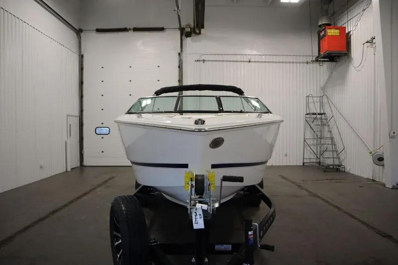 Slide: The Image of 2025 Four Winns H2 Freedom boat in a spacious indoor storage facility. - 6