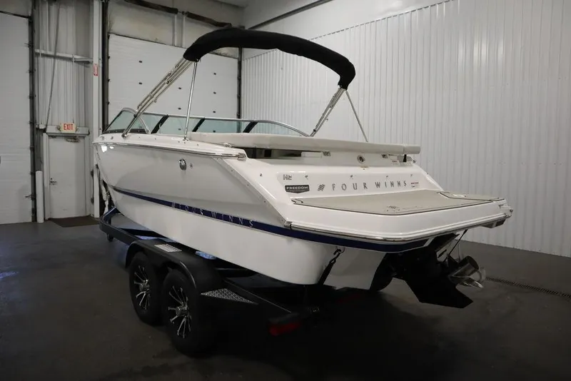 Slide: The Image of 2025 Four Winns H2 Freedom boat on trailer in indoor storage facility. - 7