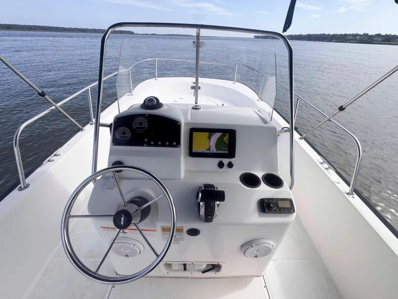 Slide: The Image of 2014 Boston Whaler 210 Montauk boat console with steering wheel and navigation system. - 11