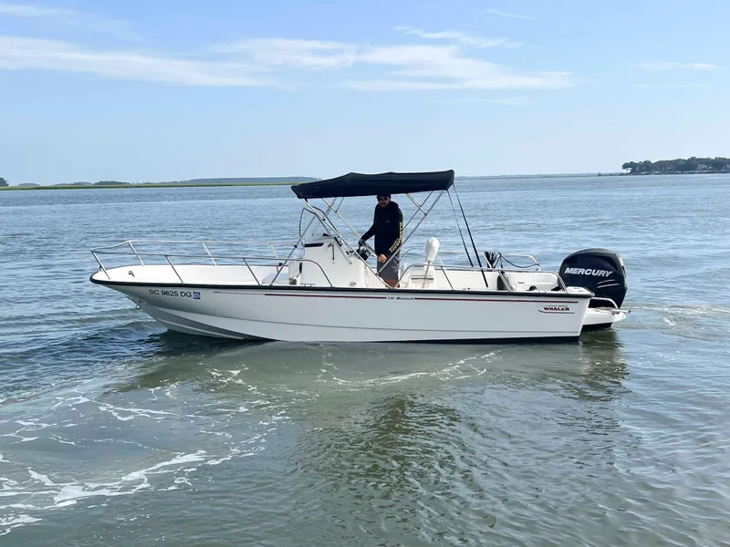 Slide: The Image of 2014 Boston Whaler 210 Montauk boat on calm water with Mercury engine. - 8