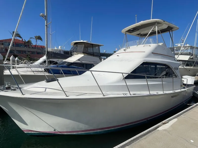 The Image of 1989 Ocean Yachts 35 Super Sport docked at marina under clear blue sky. - 0