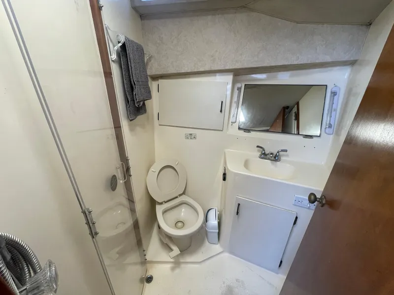 Slide: The Image of Bathroom interior of 1989 Ocean Yachts 35 Super Sport, featuring shower and toilet. - 15