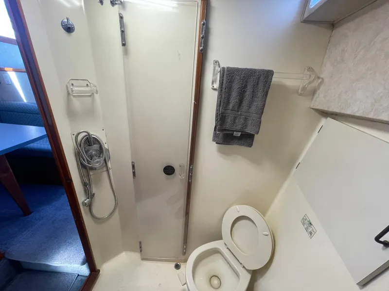 Slide: The Image of Cozy cabin interior of 1989 Ocean Yachts 35 Super Sport with nautical bedding. - 16