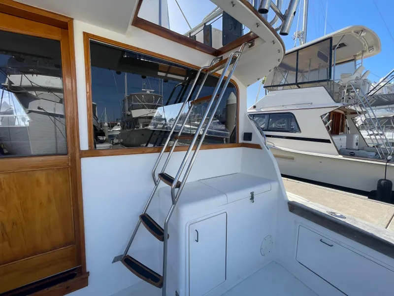 Slide: The Image of 1989 Ocean Yachts 35 Super Sport helm with marina view, featuring dual seats and controls. - 21